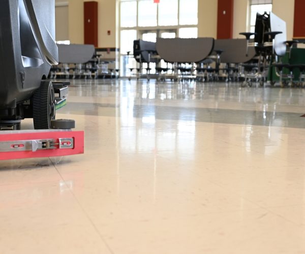 Auto,Scrubber,On,A,Floor,In,A,School,Cafeteria.,Automated