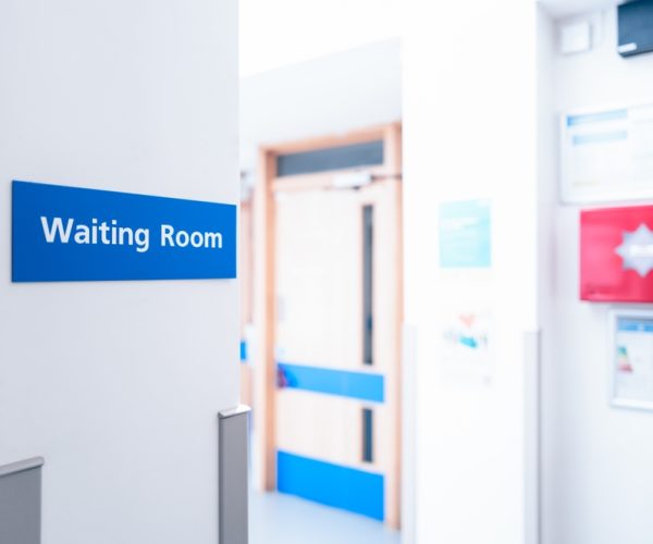 Shallow,Focus,Of,A,Typical,Waiting,Room,Sign,Seen,Within